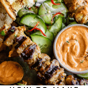 Thai peanut sauce with cucumber salad, chicken satay, and bread.