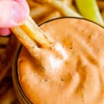 dipping french fries into chipotle mayo sauce