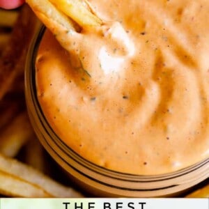 A hand dips a French fry into a bowl of creamy chipotle mayo, surrounded by more fries. Text reads: Chipotle Mayo and What to Put It On, The Food Charlatan.
