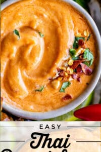easy thai peanut sauce in a bowl with crushed red pepper and peanuts
