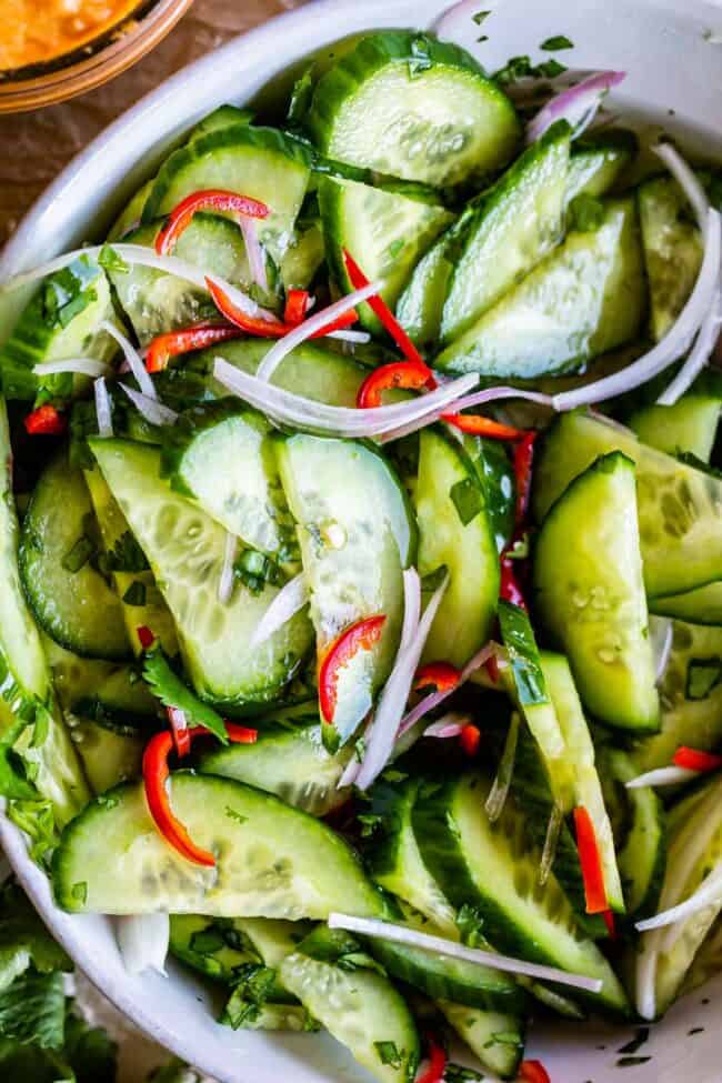 thai cucumber relish with cilantro and vinegar in a white bowl