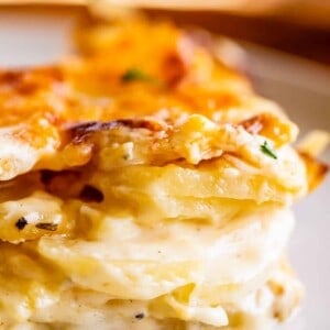 cheesy scalloped potatoes stacked on a plate