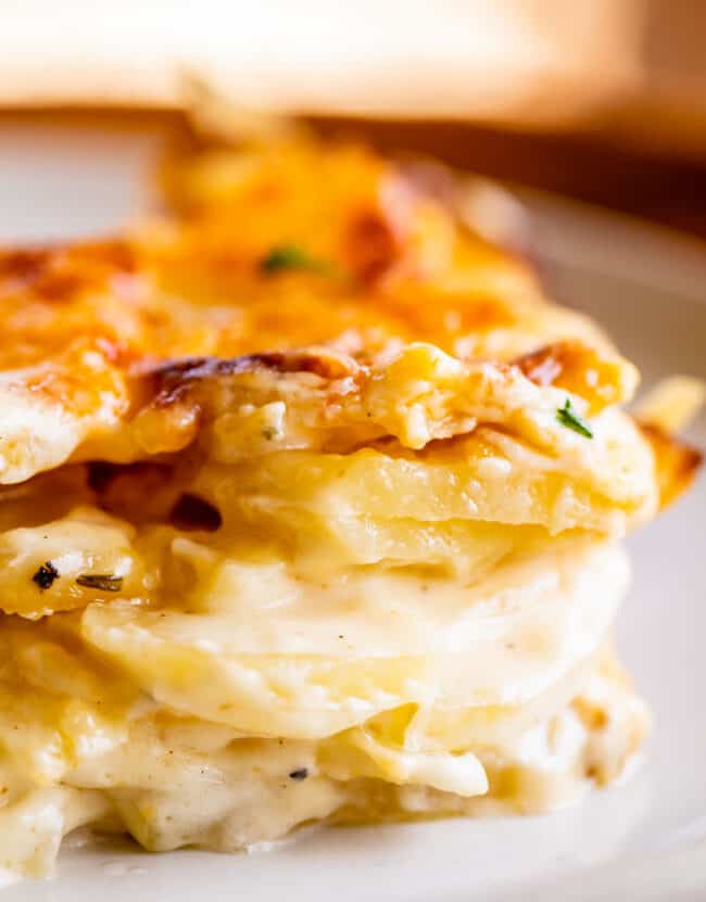 cheesy scalloped potatoes stacked on a plate