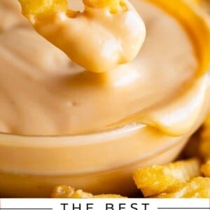 dipping crinkle fries into creamy smooth homemade cheese sauce