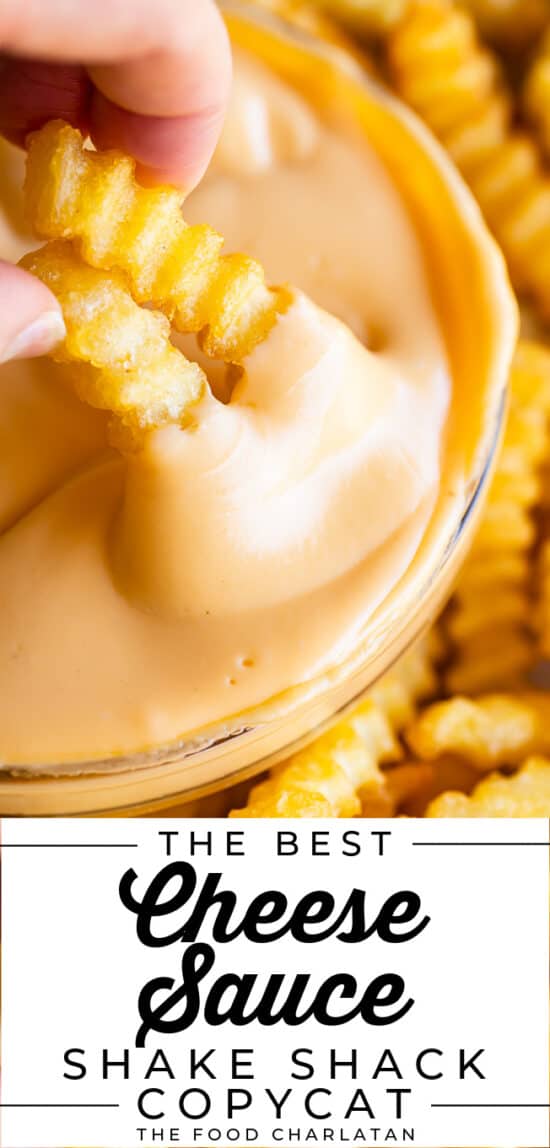 dipping two fries into a bowl of easy homemade cheese sauce