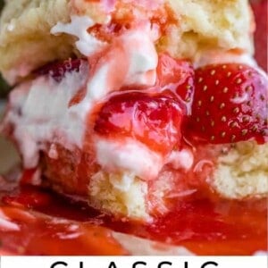 a bite taken out of strawberry shortcake on a plate