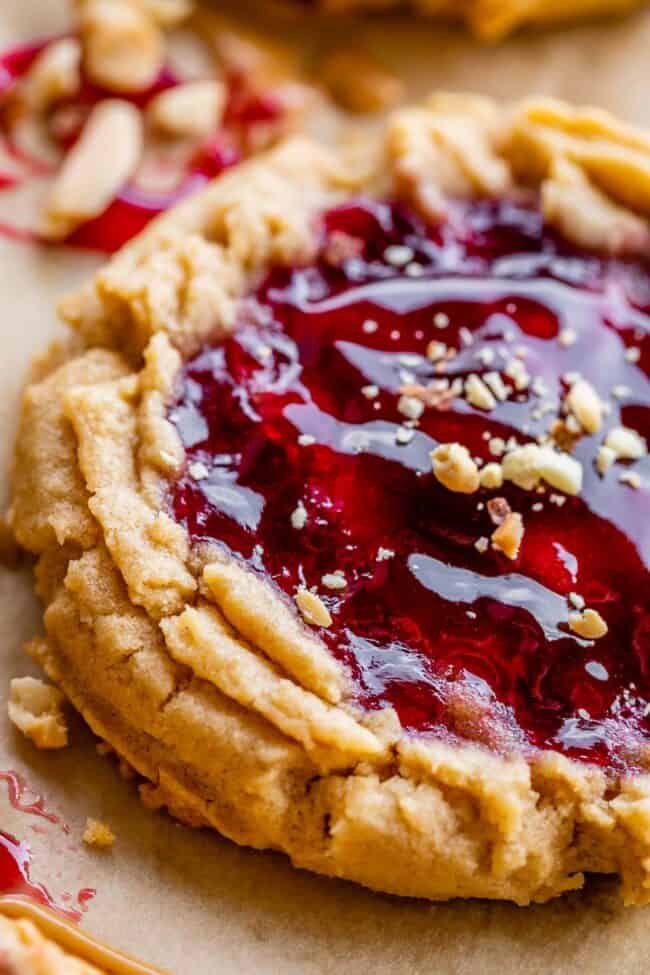 close up of the edge of pb and j cookie with jam and chopped nuts garnish