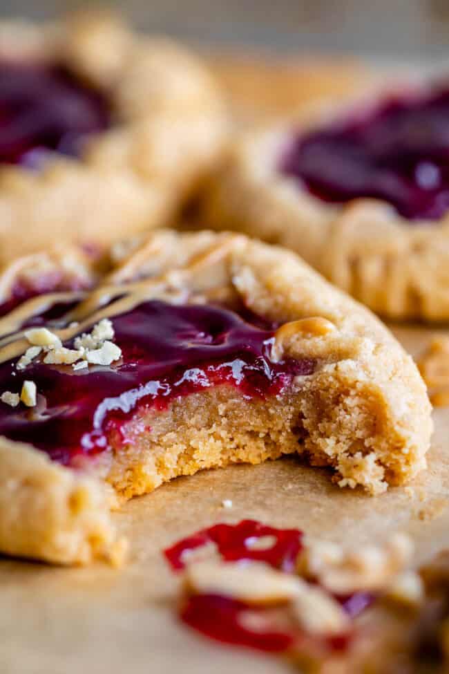 peanut butter jelly cookie with a bite taken out and jam on top