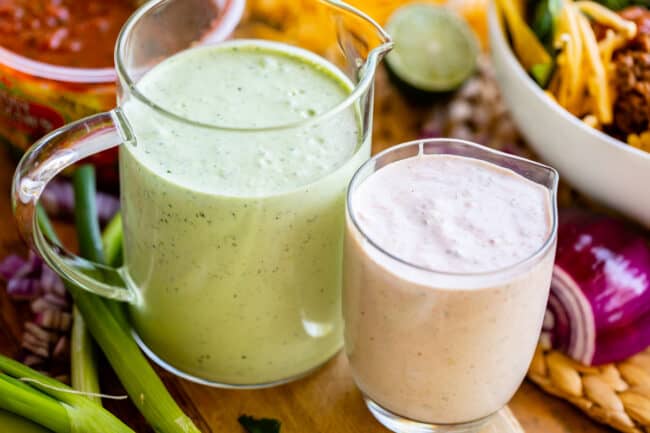 two types of salad dressing in glass measuring cups