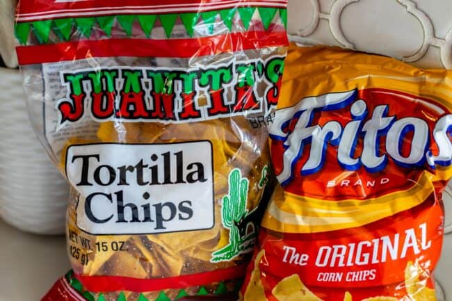 bag of Juanitas chips and bag of Fritos on white counter.