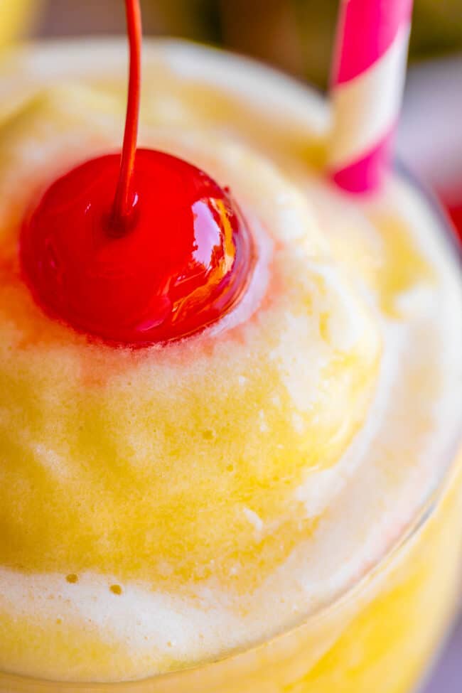 close up shot of a virgin pina colada with a maraschino cherry.