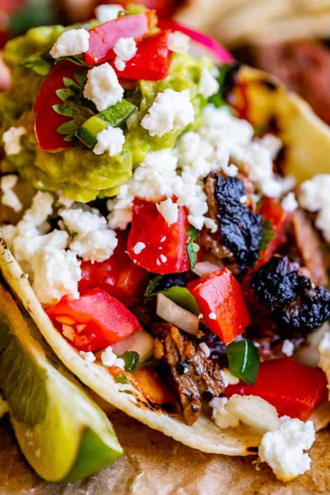 carne asada seasoning with pico de gallo, limes, and tortilla.