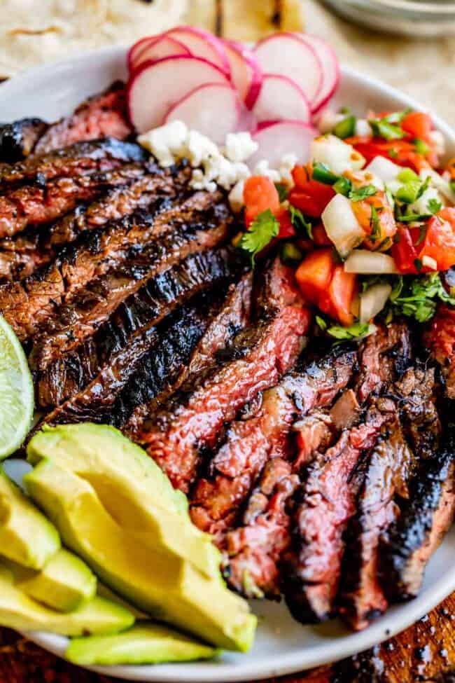 carne asada recipe on a place with garnishes