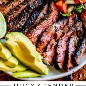 carne asada recipe with garnishes on platter