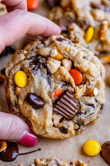pretzel cookies with peanut butter and chocolate held in hand