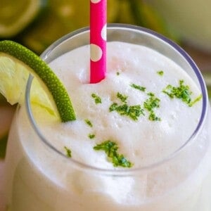 brazilian lemonade in a glass with a pink straw
