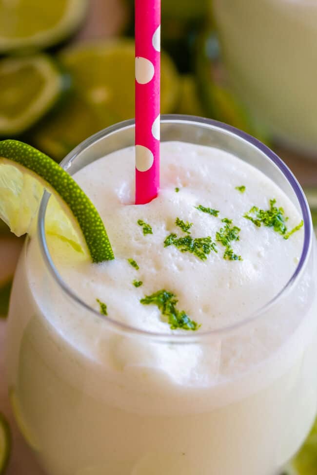 brazilian lemonade in a glass with a pink straw.