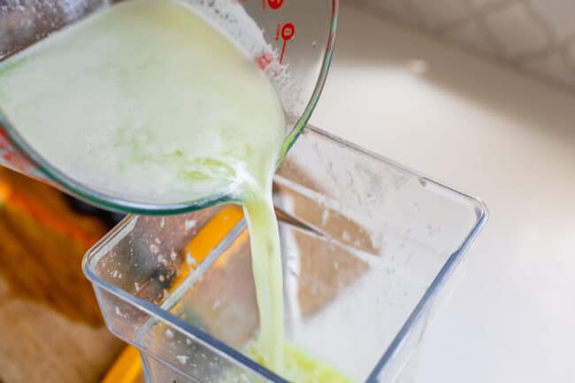 pouring limeade into a blender.