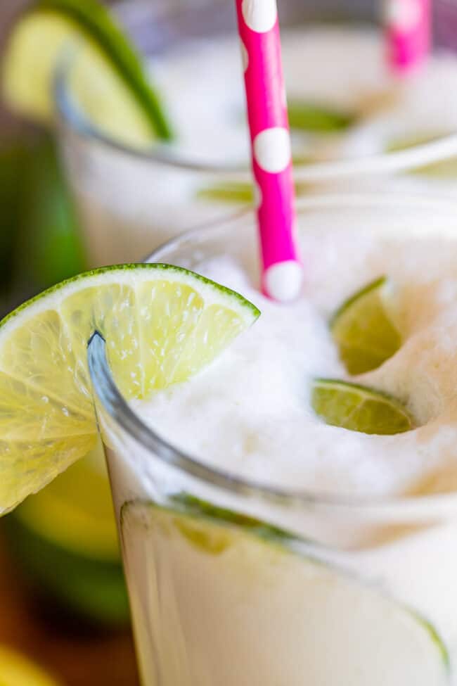 Brazilian limeade recipe in a glass with foam on top.