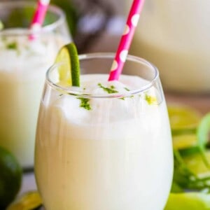 brazilian lemonade frozen limeade in a glass with a straw