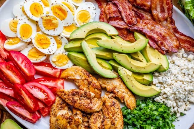 Cobb salad ingredients on a white platter.