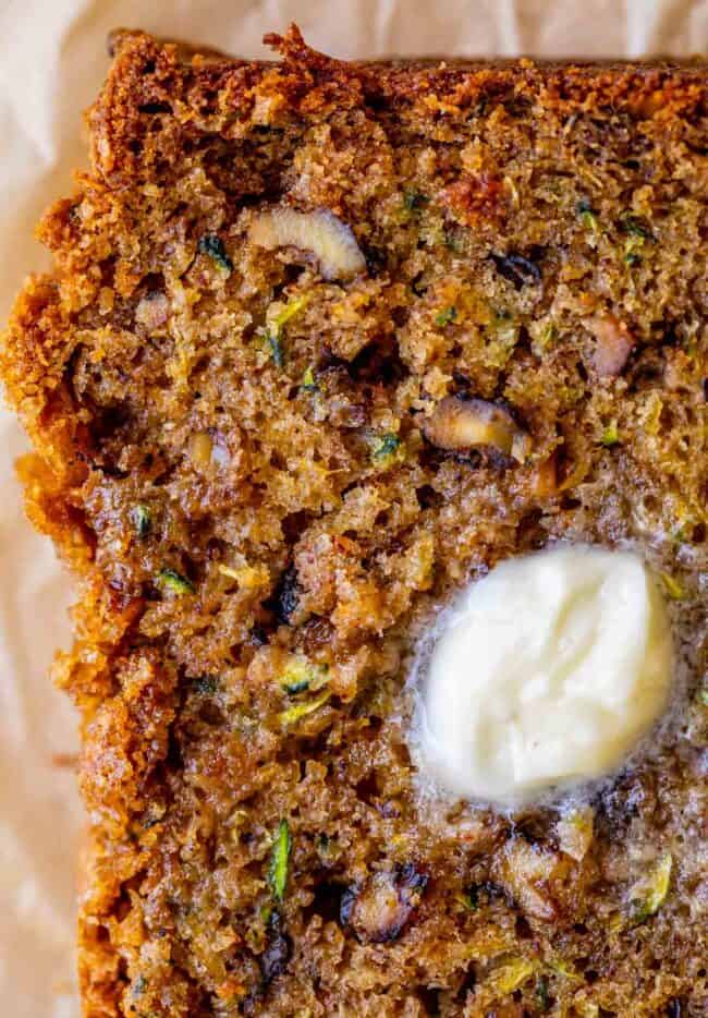 overhead shot of a slice of zucchini bread topped with melting butter.