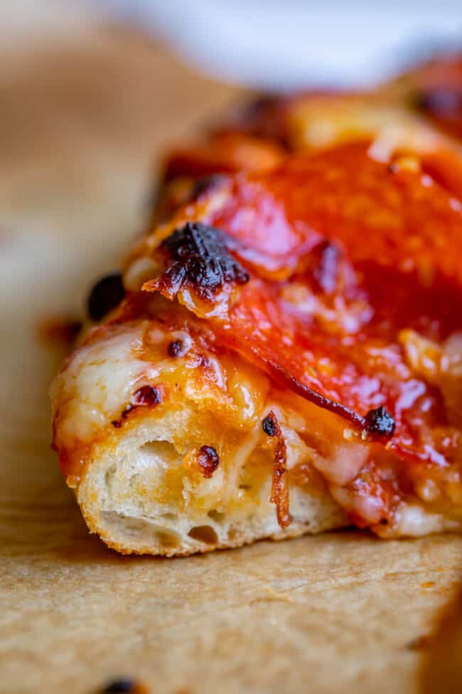 baked pizza dough with pepperoni and mozzarella