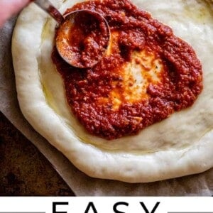 pizza sauce from scratch being spread on dough