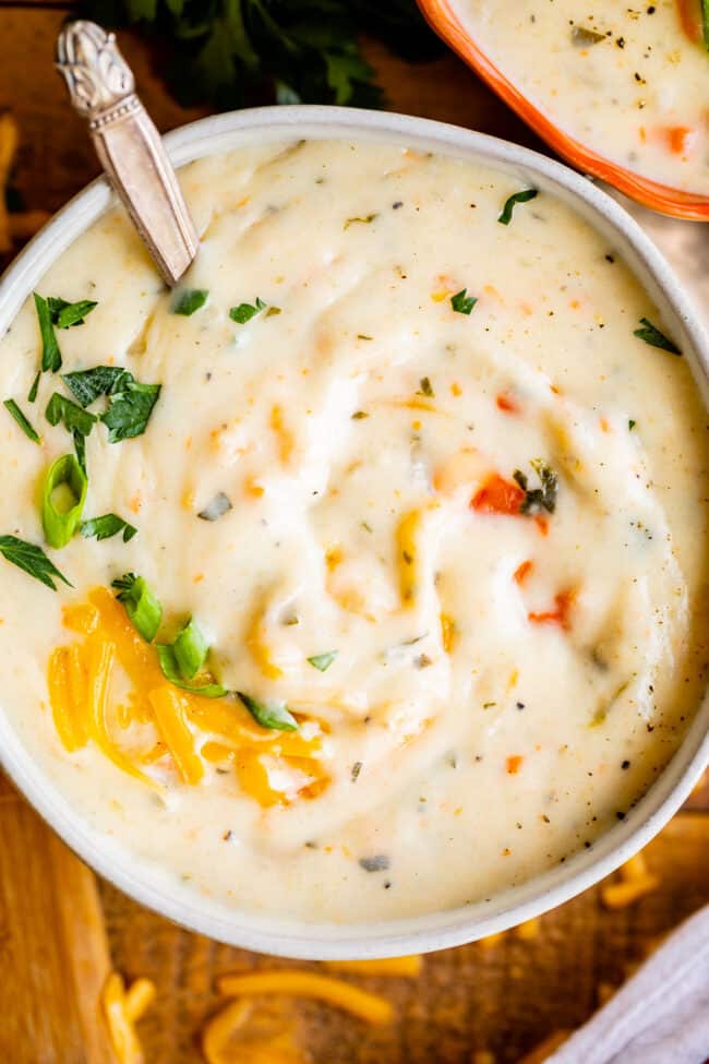 potato soup recipe in a white bowl with garnishes