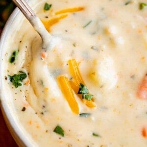 cream of potato soup in a bowl with a spoon and cheese