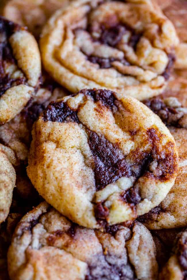 cinnamon roll cookies recipe stacked on a baking sheet