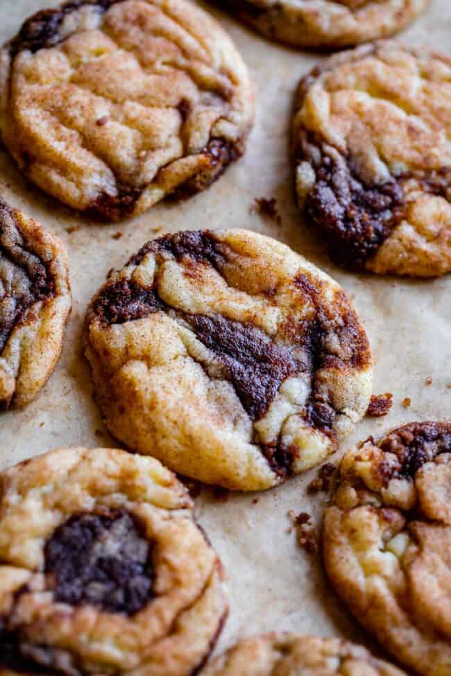 cinnamon roll cookies with cinnamon swirl on a baking sheet