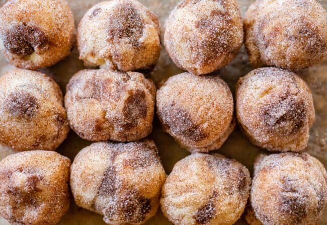 raw dough balls lined up on a baking sheet, shot from overhead