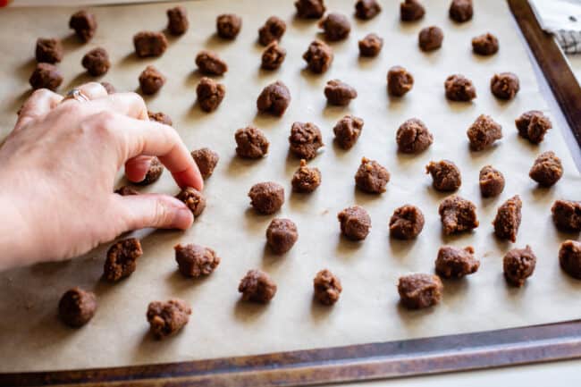 small marble size balls of cinnamon roll filling on a baking sheet