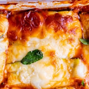 zucchini noodle lasagna in a white pan with basil