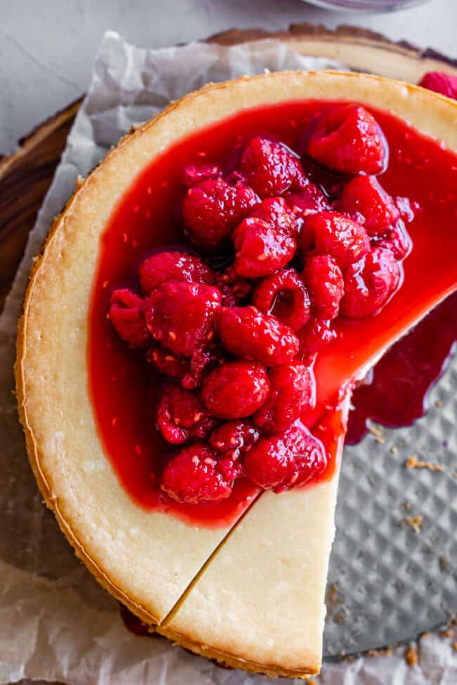 overhead shot of classic cheesecake recipe with raspberry sauce on top