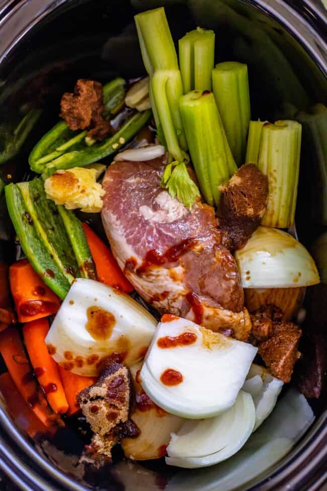 pork shoulder, celery, onion, carrots, jalapeno in a crock pot from over head