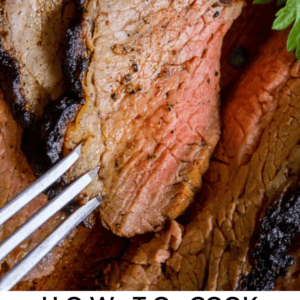 a slice of grilled tri tip with a metal fork.