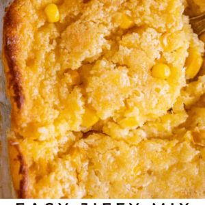 A close-up of a baked creamed corn casserole in a glass dish, featuring Jiffy Mix, with golden crust and visible corn kernels. A bowl of corn appears in the background. Text reads: Easy Jiffy Mix Creamed Corn Casserole.