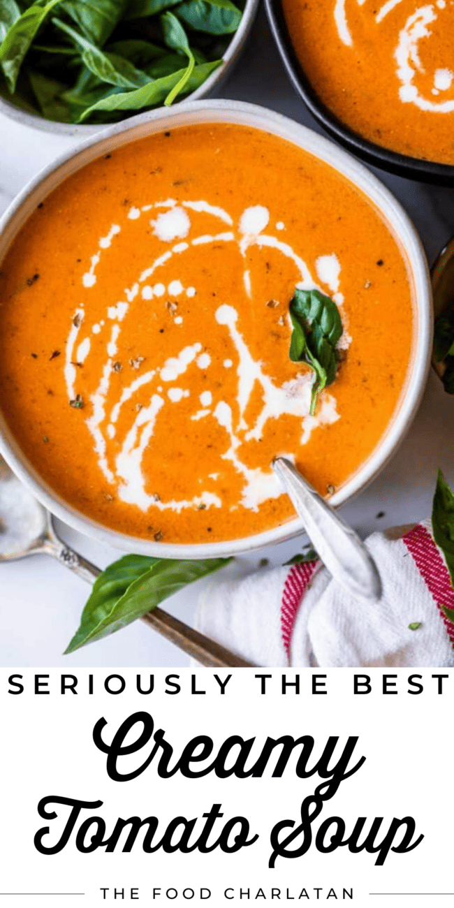 a bowl of creamy tomato soup with fresh basil garnish.