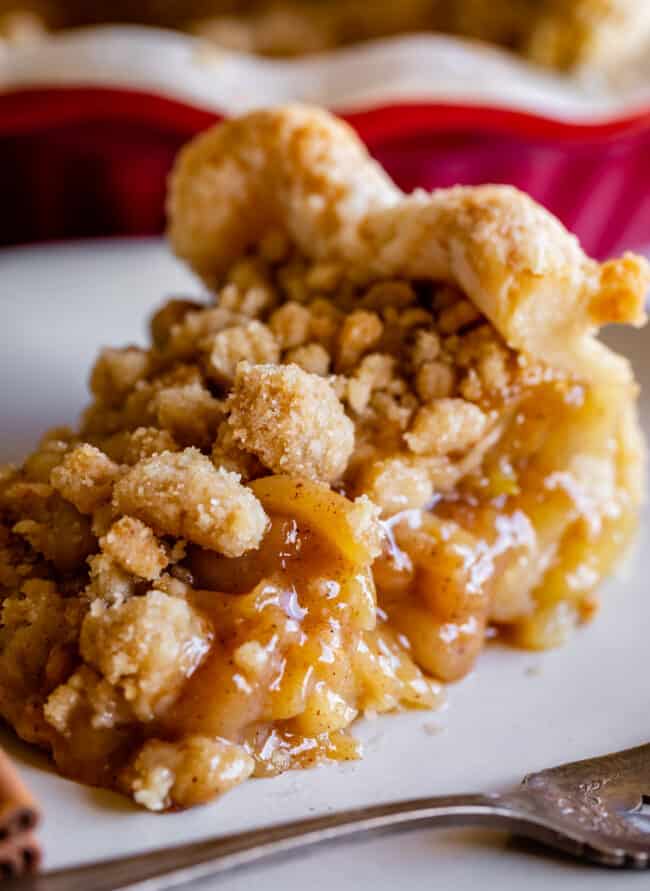 a slice of crumble top dutch apple pie on a plate.