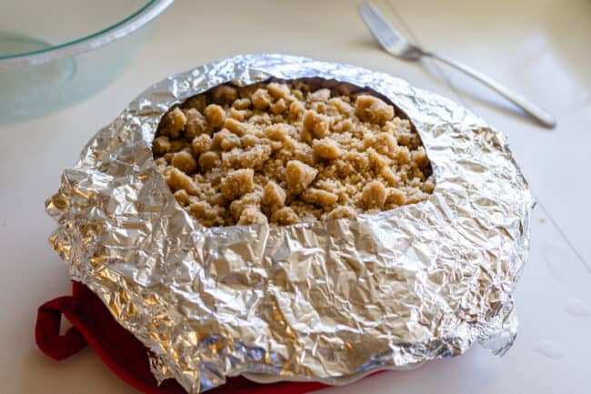 tin foil pie crust cover over Dutch apple pie to shield crust from burning.
