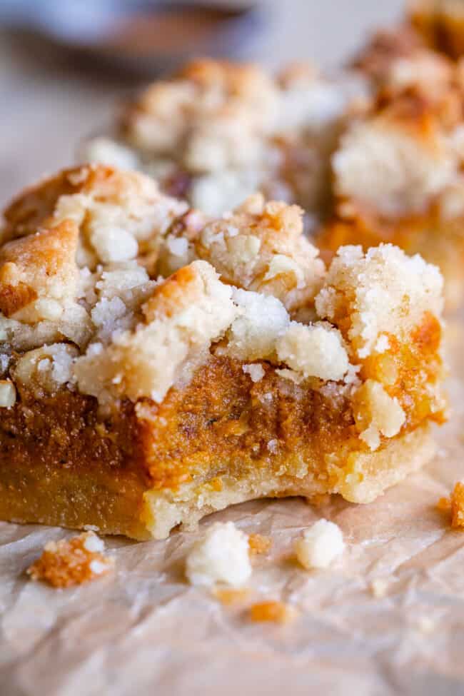 pumpkin pie bars recipe with streusel and crust on parchment paper