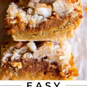 pumpkin pie bars with shortbread crust stacked on parchment paper