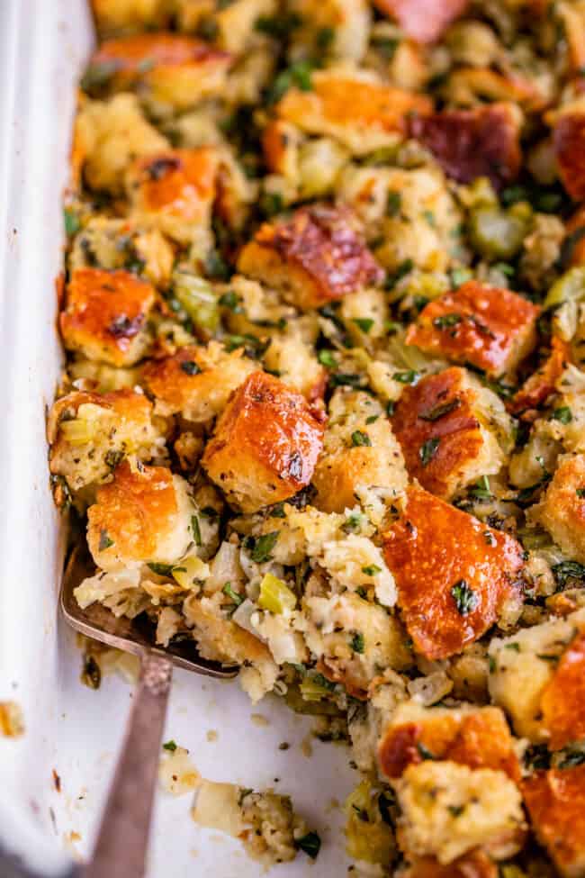 Thanksgiving stuffing in a white dish with spoon