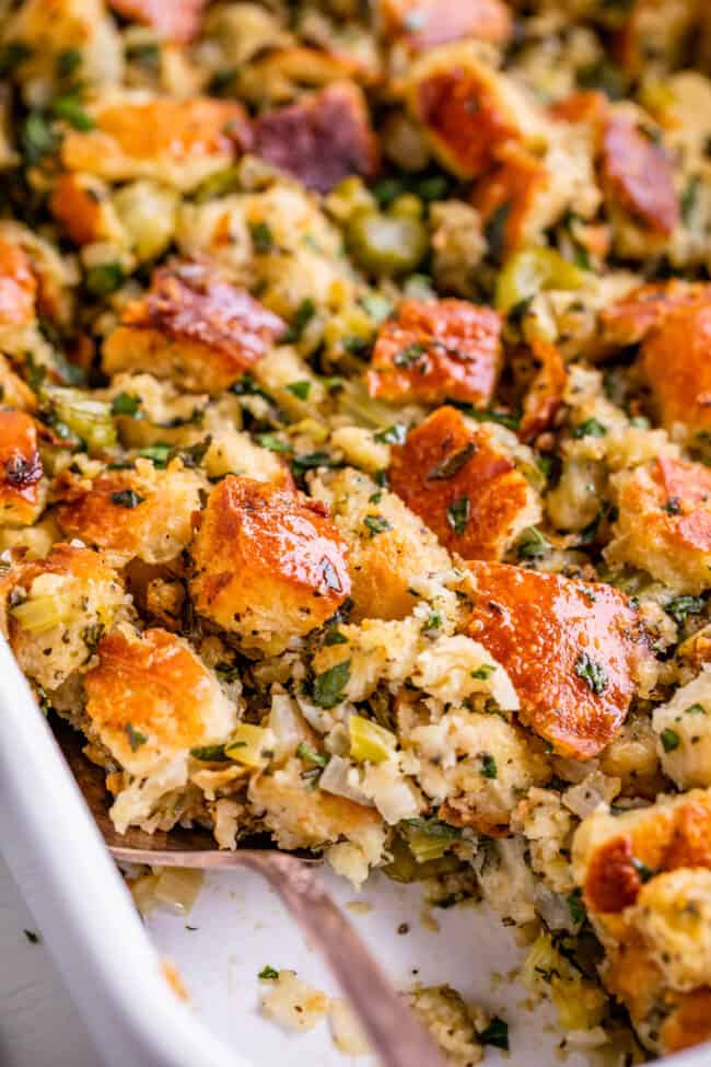 best stuffing recipe in a white dish from the side with a spoon