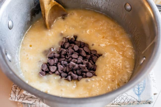 adding chocolate chips to boiling fudge mixture.