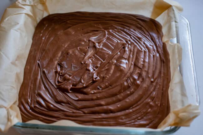 fudge poured into glass pan lined with parchment paper.