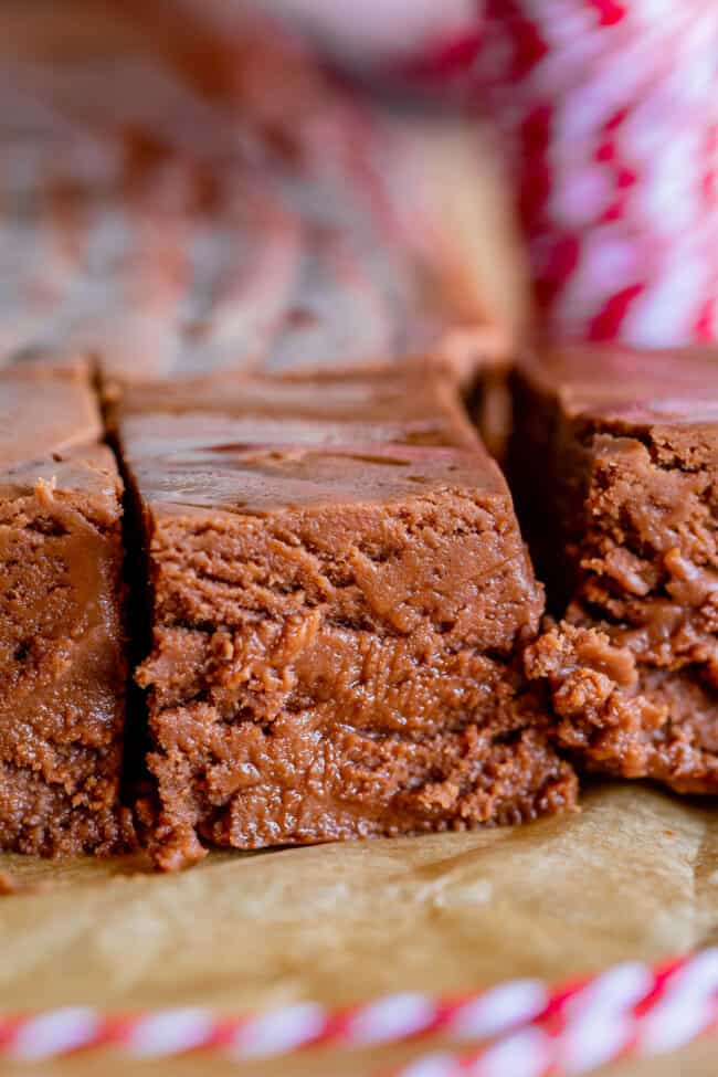 fudge sliced into squares on parchment paper.