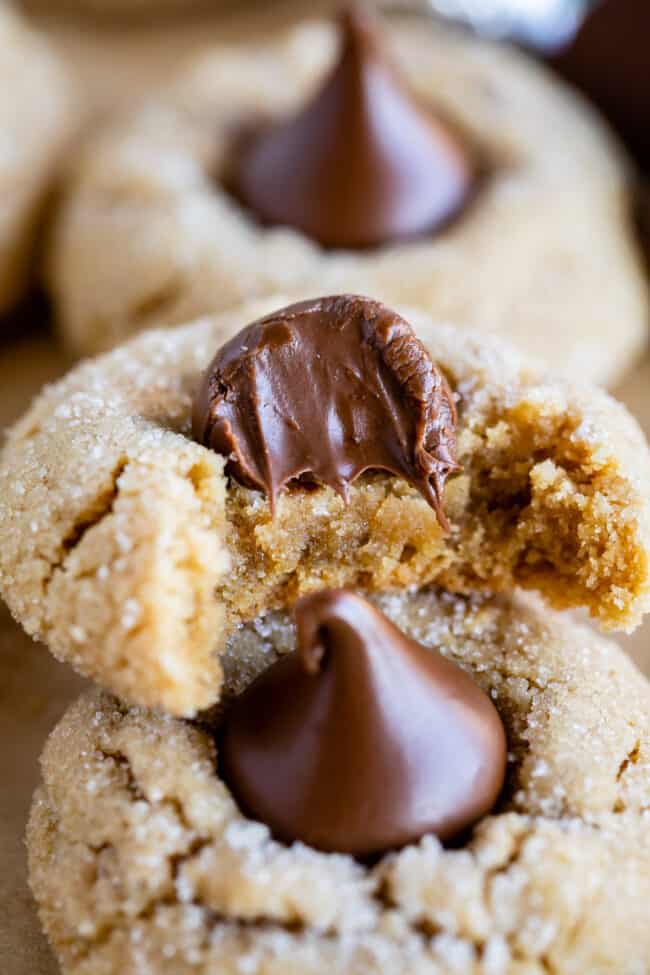 half a peanut butter blossom cookie stacked on another cookie.